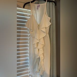 White dress with ruffle and zipper front detail.